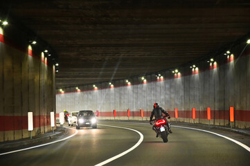 Biker backview driving in curved tunnel deliberated motion blur