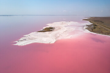 Coast with pink water. Aerial view of majestic landscapes of lemurian salt pink salt lakes water island in Henichesk, Ukraine. - 548229116