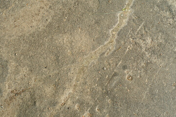 Background with old dusty asphalt interspersed with stone. The road from the asphalt-concrete...