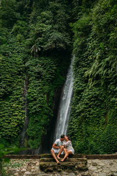 Paar bewundern einen sch&ouml;nen Wasserfall in Indonesien. Paar im Urlaub in Bali. Flitterwochen-Reise. Das Paar ist in Asien unterwegs. Urlaub auf der Insel Bal