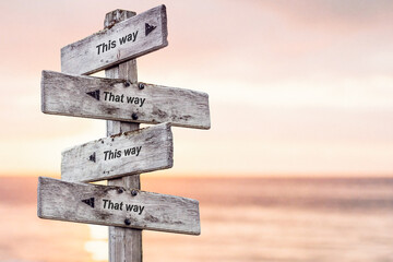 this way that way this way that way text written on wooden signpost outdoors at the beach during sunset