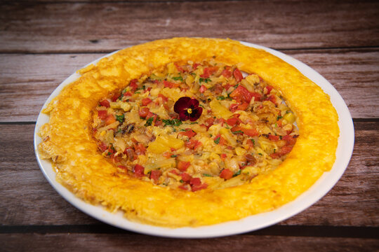 Recipe Omelette with peppers, onions, tomatoes, courgettes and coriander. High quality photo