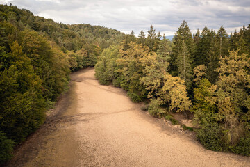 Fototapeta na wymiar Landscape feature, dried channel river on the forest hill, after long summer drought season, drone shot.