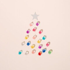 Colorful diamonds on cream background with mirror star. Christmas tree aesthetic decoration. Jewelry concept.