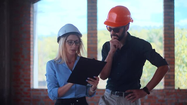 a real estate building project managers  in helmets inspecting the building