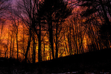 Colorful clouds during a morning sunrise in Winter in Windsor in Upstate NY.  Pink, Orange, Blue, and Magenta are some of the colors glowing this morning.
