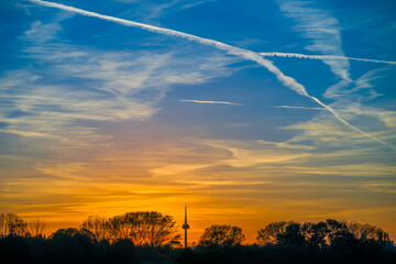 Colorful sky at sunset with traces of aircraft