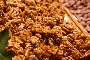 sweet walnut kernels in caramel glaze on counter in market