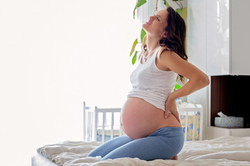 Young beautiful pregnant woman, in pain with labor contraction