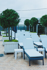 Deckchairs stand in a row near the pool, places for comfortable relaxation on deckchairs