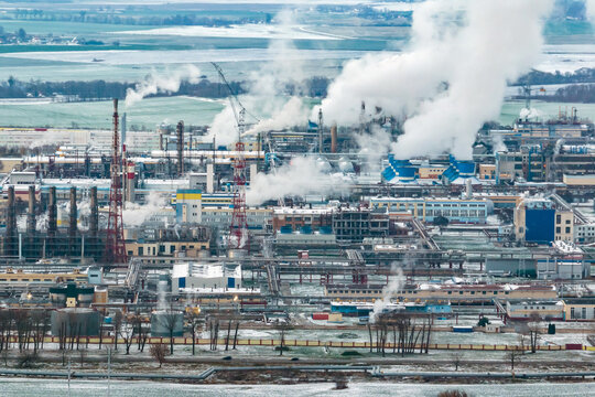 winter aerial panoramic view on smoke of pipes of chemical enterprise plant. Industrial landscape environmental pollution waste plant. Air pollution concept. © hiv360