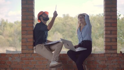 The specialist builder and construction architect are inspecting the renovation object