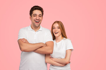 Happy young couple with crossed arms