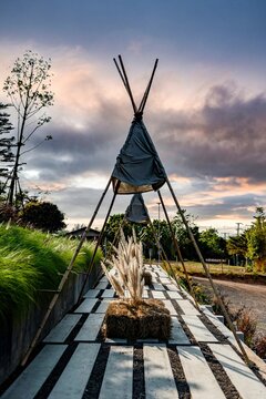 Vertical shot of decorative tipi tents at sunset in front of a cafe in Nakhon Ratchasima, Thailand.