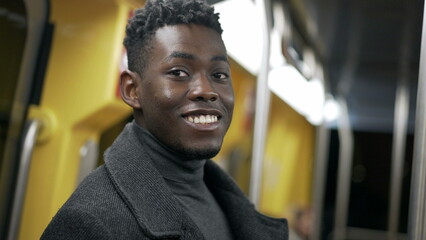 Portrait black man standing at metro subway commuting