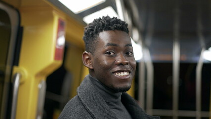 Portrait black man standing at metro subway commuting