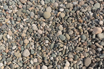 Small round stones background. Stone texture. Rough surface of small pebble stone.