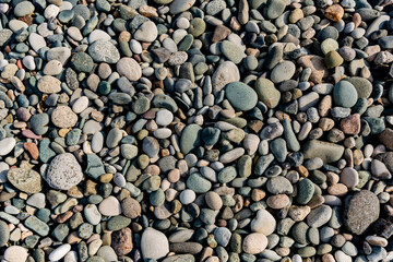 Small round stones background. Stone texture. Rough surface of small pebble stone.