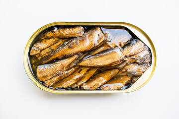 Sprats with oil in the open tin can on the white background, close up image