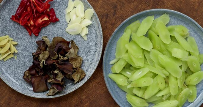 Ingredients for stir fry celtuce (stem lettuce) with wood ear mushrooms (mun) dish. Chinese cuisine. Table spin.