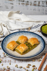 Pistachio baklava on a white wooden background. Turkish cuisine delicacies. Turkish baklava. close up