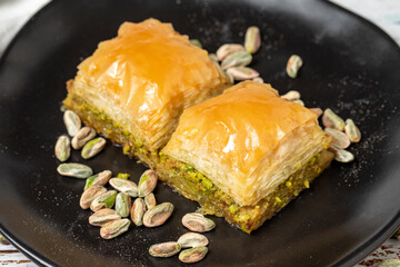 Pistachio baklava on a white wooden background. Turkish cuisine delicacies. Turkish baklava. close up