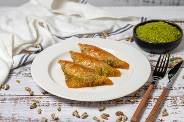 Sobiyet baklava on a white wooden background. Turkish cuisine delicacies. Turkish baklava. close up