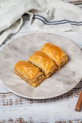 Walnut baklava on a white wooden background. Turkish cuisine delicacies. Turkish baklava. close up