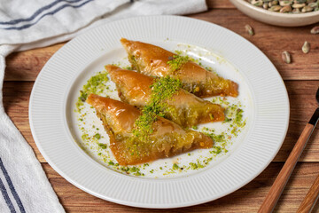 Sobiyet baklava with pistachio on wooden background. Turkish cuisine delicacies. Turkish baklava. close up