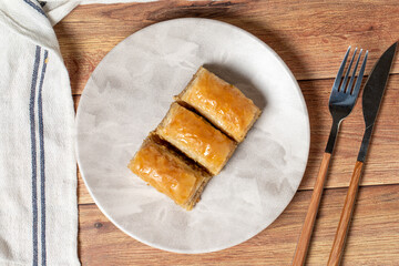 Walnut baklava on wooden background. Turkish cuisine delicacies. Turkish baklava. Top view