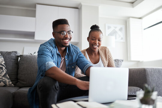 Black couple, laptop and planning finance budget, bills and loan with network connection or home wifi on living room couch. Man and woman on social media, banking website or doing online shopping