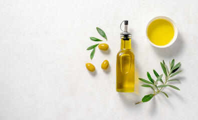 Olives and olive oil in white bowl with bottle of olive oil on white background. Mockup for package. Copy space. - 548243382
