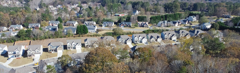 Panorama suburban subdivision sprawl with row of high density brand new two story houses along park autumn leaves outside Atlanta, Georgia, USA - obrazy, fototapety, plakaty