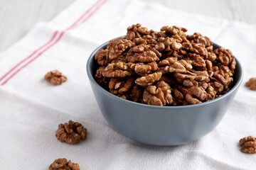 Raw Organic Walnuts in a Bowl, side view. Copy space.