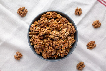 Raw Organic Walnuts in a Bowl, top view. Flat lay, overhead, from above.
