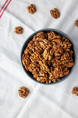 Raw Organic Walnuts in a Bowl, top view. Flat lay, overhead, from above.