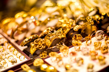 Showcase with golden jewerly in big market. Dubai Gold Souk