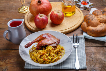 Spelled with duck leg in a plate on the festive table for Rosh Hashanah.
