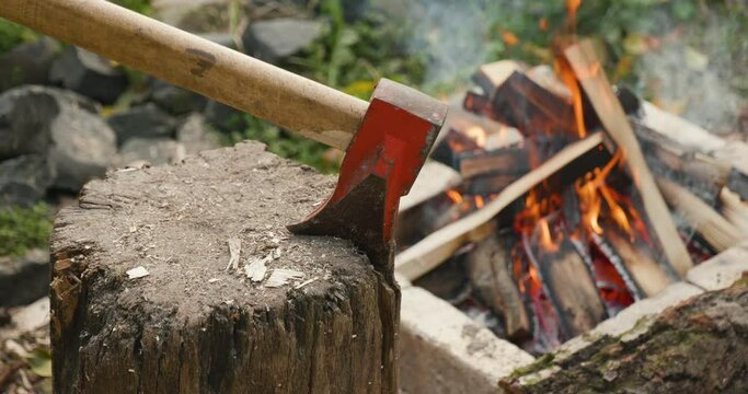 The axe hammered into the log. High quality video 6k 4:2:2 10bit downscale 4k