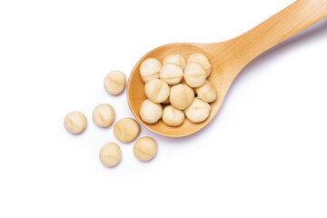 Macadamia nuts in wooden ladle isolated on white background. Top view. Flat lay.