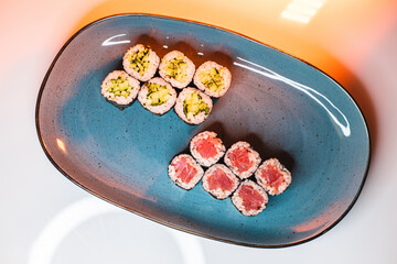 Asian food. Rolls on a neon background. Sushi, sashimi, nigiri.