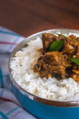 Sri Lankan style spicy chicken curry with white raw rice. Mouth watering, delicious Sri Lankan cuisine.