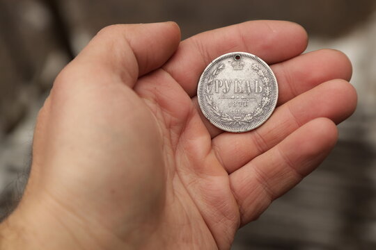 Rare vintage silver coin one ruble of Russian Empire in hand