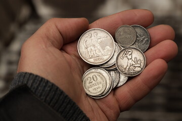 Old silver soviet coins in hand