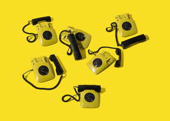 Retro yellow landline rotary telephones. Communication  background.