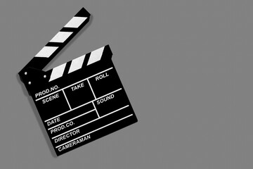 Fototapeta na wymiar Movie clapperboard for shooting videos and movies on a grey background copy space