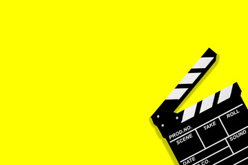 Fototapeta na wymiar Movie clapperboard for shooting videos and movies on a yellow background plenty of space for text