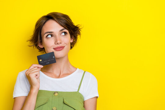 Closeup photo of pretty cute nice womam bob brown hair dreaming about new platinum credit card look mockup isolated on yellow color background