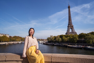 Happy female tourist on embankment in Paris