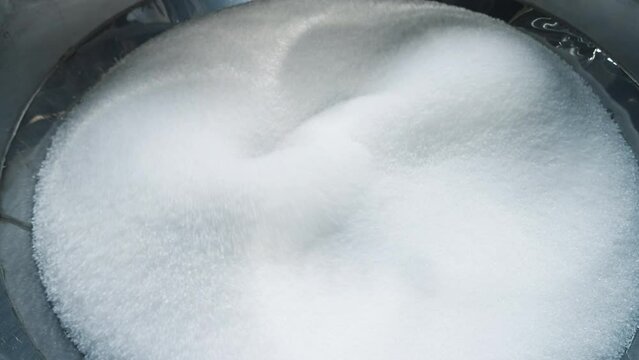 Automated equipment deals with the production of ecological material out of polymer. Automated production machine processing the polymer. Automated production machine mixing the polymer granules.